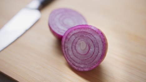 a chopped red onion sits on a chopping board