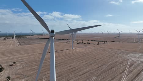 stationary aerial shot of spinning wind turbine