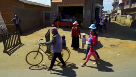 driving along busy african street in madagascar. wide shot tracking