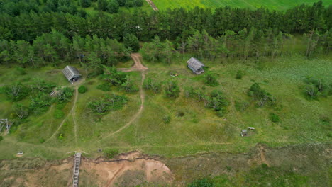 cabin cottage bungalows in a green countryside landscape - aerial view