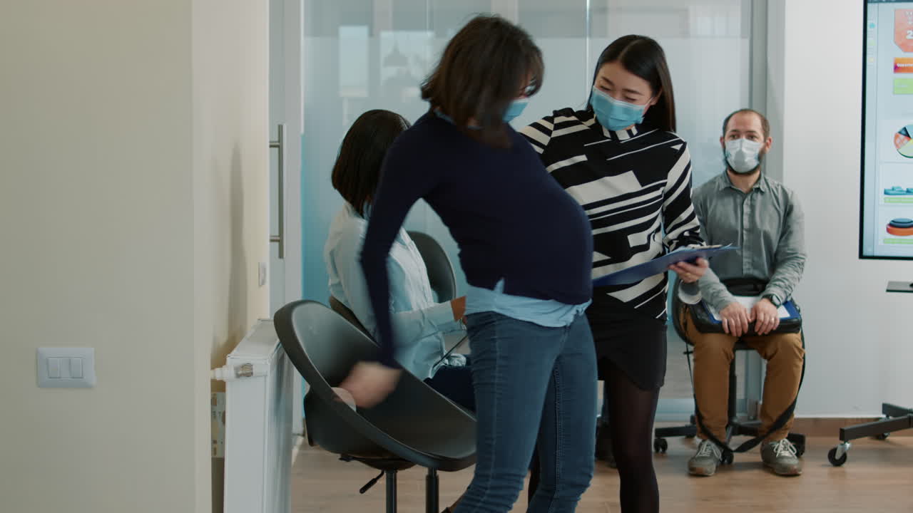 HR recruiter taking pregnant candidate to job interview meeting
