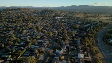 aerial sideways motion across rivett’s leafy streets and rooftops as the sun casts long golden shadows on the suburb