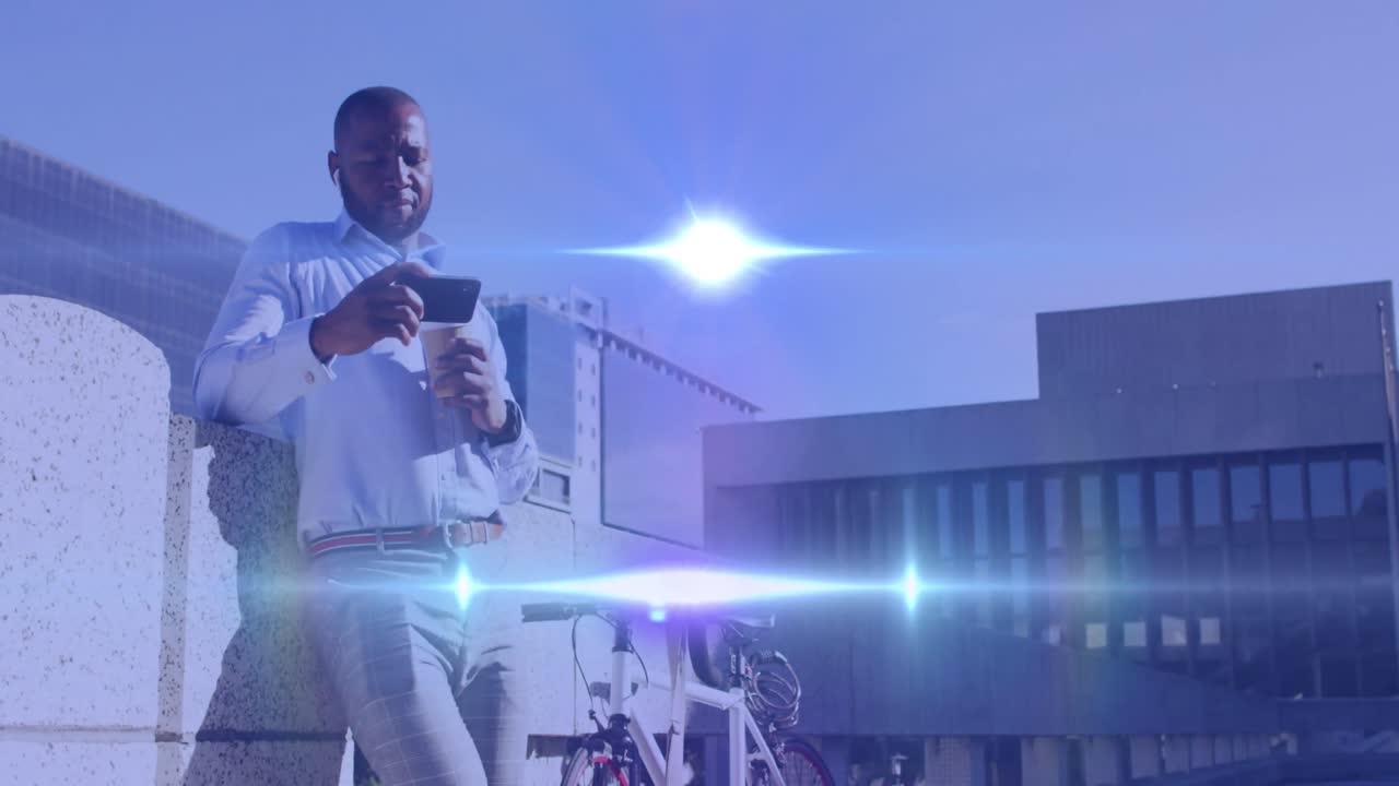 Animation of light spots over african american man using smartphone