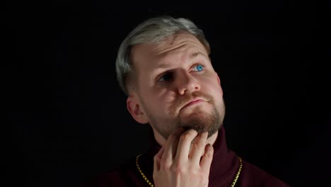 Thinking-man-looking-around-thinks-scratches-at-temple-comes-up-with-ideas-raised-finger-up