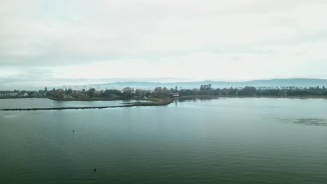 a morning aerial view of crab cove in alameda, california, featuring its diverse coastline and peaceful marine setting