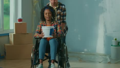 a white man is wheeling an african american woman (1).mov | adult, african, american, apartment