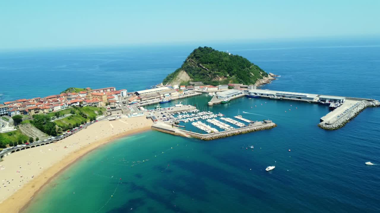 Aerial View of a Coastal Town with Beach, Marina and Island