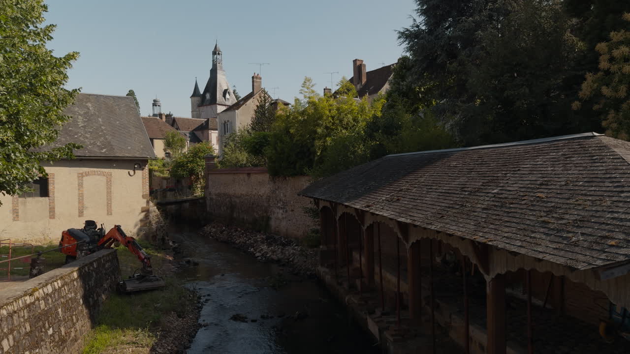 Profile view of tranquil Belfry with small canals winding through the town of Saint-Fargeau in France