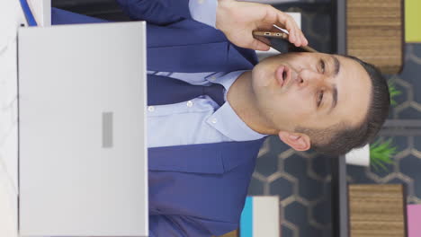 Vertical-video-of-Aggressive-businessman-talking-on-the-phone-angrily.