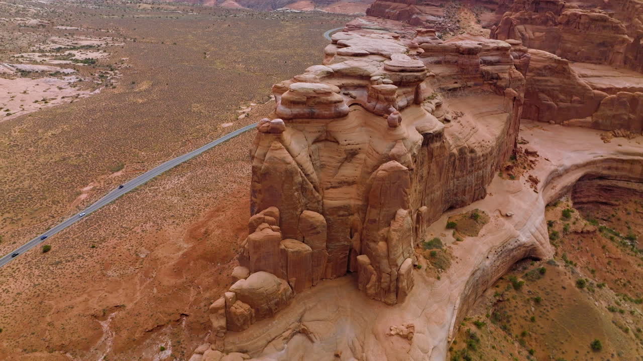Huge rocks with rounded tops at national park. Drone rising over Bryce canyon and road passing through it. Aerial perspective.