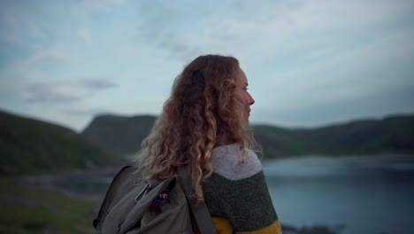 caucasian woman staring at the lake in norway