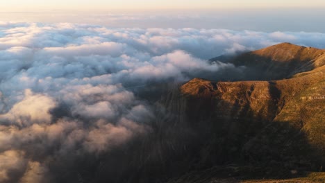 majestic aerial view of clouds over the mountains during sunrise in genoa, liguria