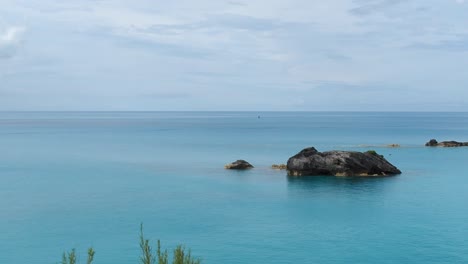 a mostly cloudy day with sunny breaks shinning over bermuda waters