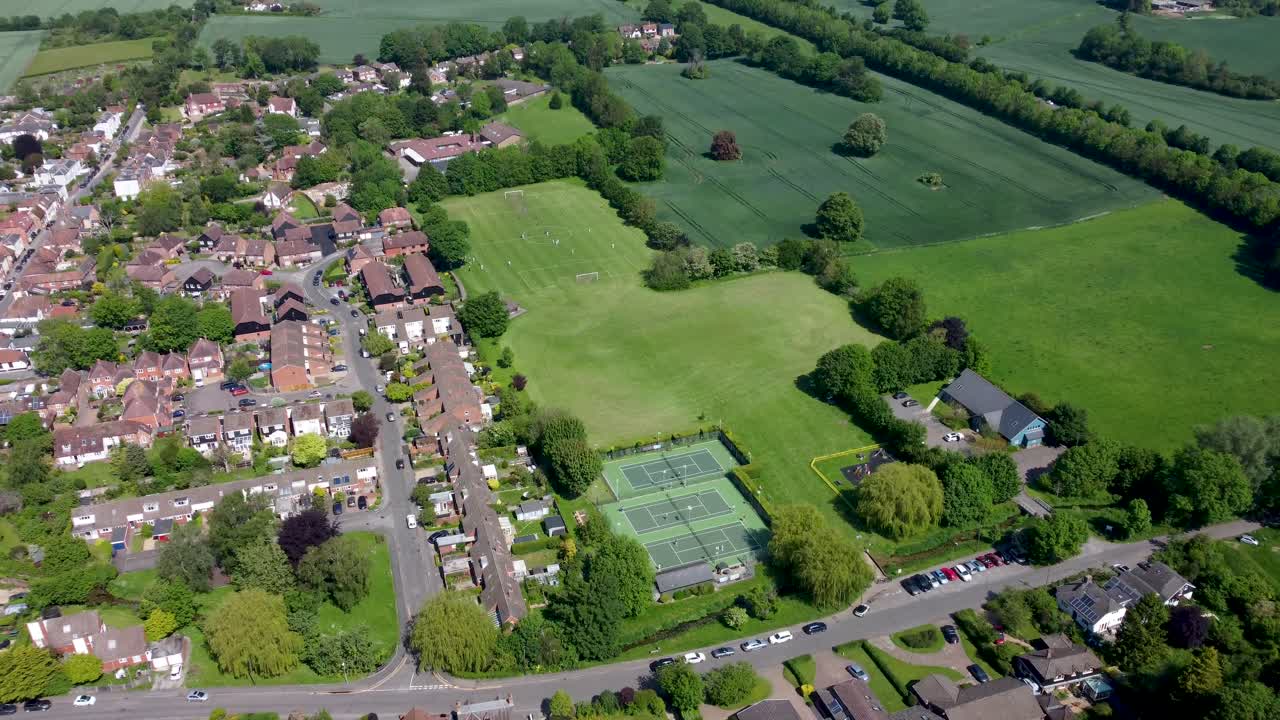 4K drone video of the village of Bridge near Canterbury with tennis courts underneath