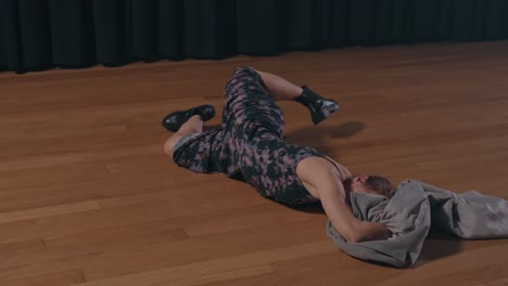 floor based dance sequence with fabric in soft light studio environment