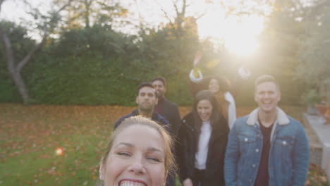 portrait of multi cultural group of friends posing for selfie on outdoor walk in countryside