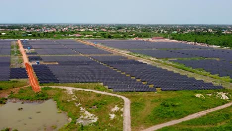 aerial reverse overview of jambur solar pv farm under construction during rainy season