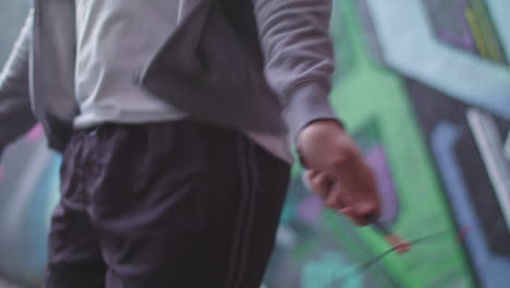 Close-Up-Shot-of-Young-Athletic-Man's-Hands-Whilst-He's-Jumping-Rope---Skipping-in-an-Underpass,-In-Slow-Motion