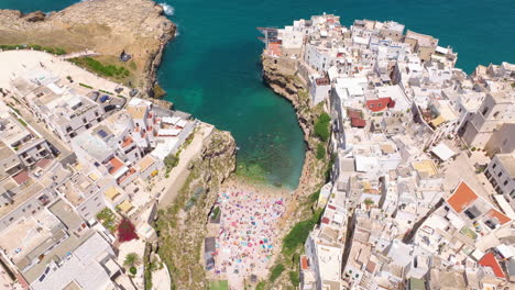 Scenic-Landscape-Of-Lama-Monachile-Beach-In-Polignano-a-Mare,-Italy---Drone-Shot