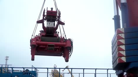 crane lifting heavy equipment at a port