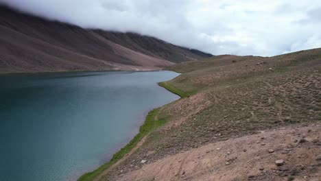 aerial-of-Chandra-Taal-Lake-in-the-Himalaya-Mountains-of-India-on-cloudy-day-with-no-tourists