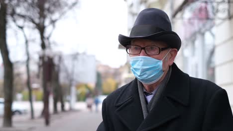 grandpa in a protective mask against covid-19. new pandemic in 2022