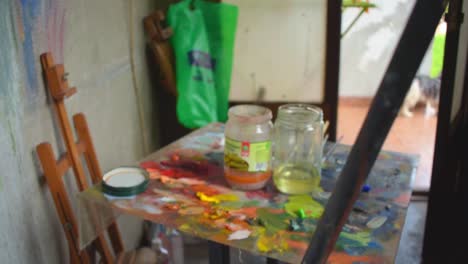 atelier painting artist, colors and frame sidewards right slow motion