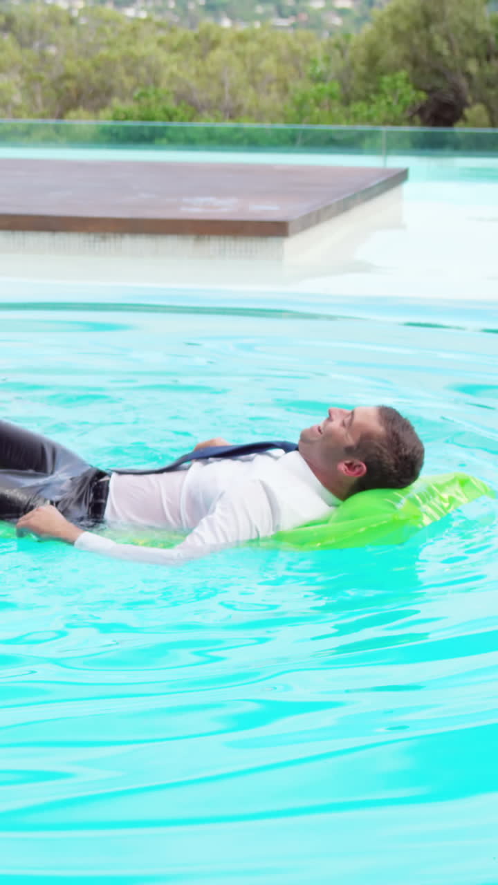 Businessman lying on lilo