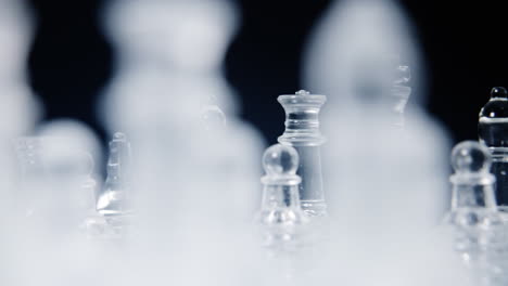 a magnificent chessboard, with two different full sets of chess pieces made of glass, on a spinning surface, showing both factions ready to fight