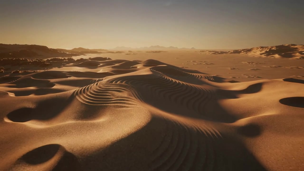 Drone in panoramica che rivela una duna di sabbia increspata al tramonto, mostrando creste formate dal vento e avvallamenti poco profondi.