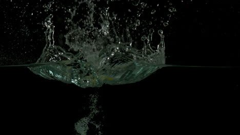 Pear-plunging-into-water-on-black-background