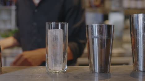 a talented bartender crafts a delicious cocktail behind the bar, highlighting the vibrant bar atmosphere