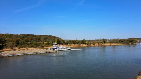 shot of drone flying over a barge with a load of sand in the middle of the lake in clarksville