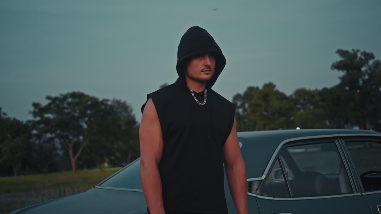 Man in Hoodie by Classic Car