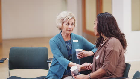 Two-Women-Talking-After-Meeting-In-Community-Center