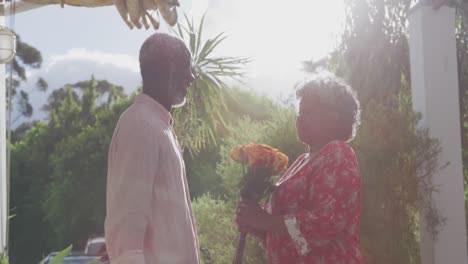 a senior african american couple spending time together in the garden in love