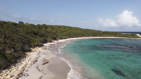 Half Moon Bay Beach in Antigua with white sand, turquoise water, and lush green surroundings