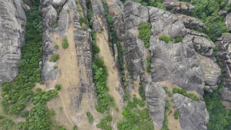 Top-view-of-spectacular-landscape-formed-of-deposits-of-stone,-sand,-and-mud-from-streams-flowing-into-a-delta-at-the-edge-of-a-lake,-over-millions-of-years-at-Meteora