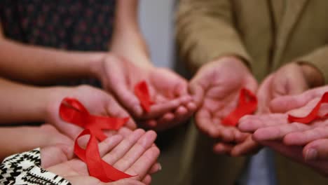 business team showing red ribbon