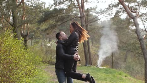 a couple's romantic walk and affectionate moments in a spring forest