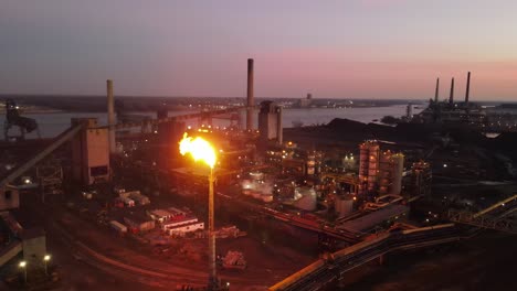 Flare-at-Zug-Island,-steel-mill,-Detroit-Michigan,-aerial-view-at-night