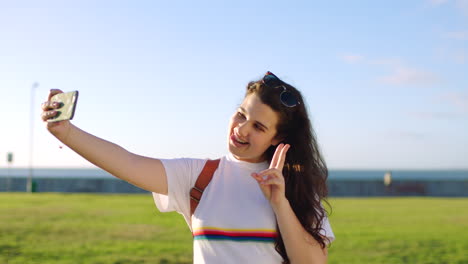 young student taking selfie in the park