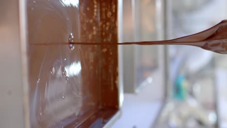 ice cream factory worker melting gourmet chocolate in an industrial pot