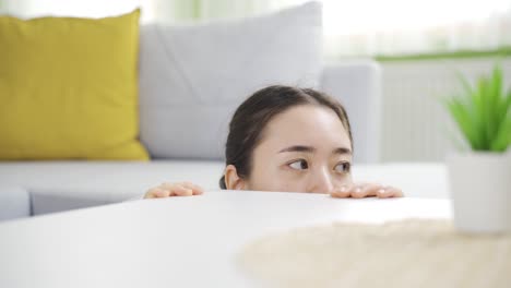 desperate young asian woman having delusions of danger at home. agoraphobia.