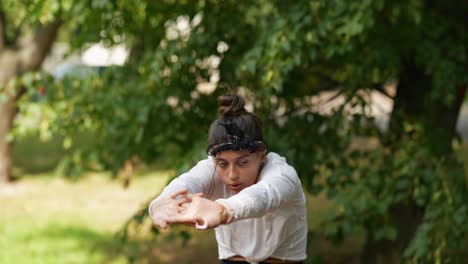 woman doing yoga or stretching exercises in a park