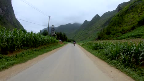 first person view of a narrow winding rough road that cuts through the mountains and valleys of northern vietnam