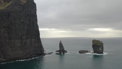 risinn og kerlingin sea stacks against gloomy sky on the northern coast of the island of eysturoy in faroe islands