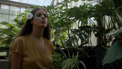 Young-girl-model-walking-around-tropical-greenhouse