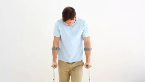 Injured-man-on-crutches-stepping-towards-camera