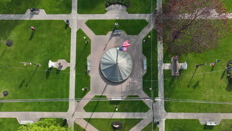 american flag waving in breeze in town center